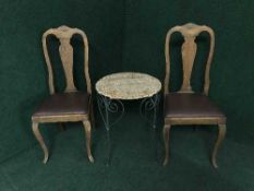 A pair of oak Queen Ann style dining chairs together with a metal and wicker table