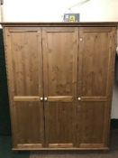 A pine triple door wardrobe