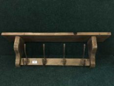 A reclaimed pine four-hook coat rack