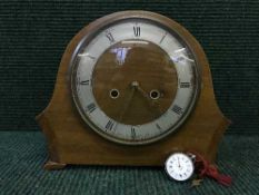 A walnut domed top mantle clock and a fine silver pocket watch