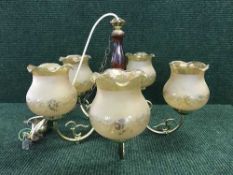 A five-way wooden and brass light fitting together with three way light fitting