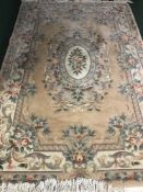 A pink fringed embossed Chinese carpet