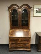 A Continental burr walnut domed bureau bookcase