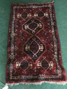 A hand-woven woolen Persian Kashgai rug
