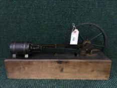 A hand-built steam piston engine on wooden stand