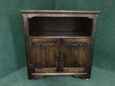 An oak linen fold record cabinet