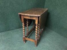 An oak barley twist gate leg table