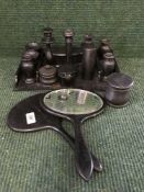 A box of ebony dressing table set, hand brushes, lidded pots,
