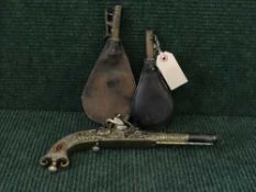 Two antique leather shot-flasks together with an ornamental flintlock pistol