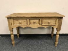 A reclaimed pine three drawer side table,