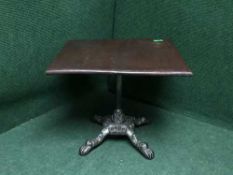 A mahogany occasional table on cast metal support