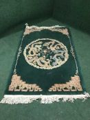 A green fringed embossed Chinese style rug