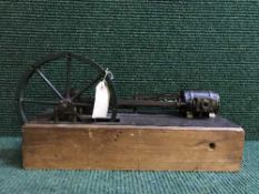 A hand-built steam piston engine on wooden stand