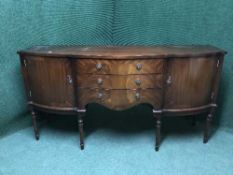 A Regency style sideboard with an oval extending dining table