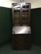 A carved oak bureau bookcase