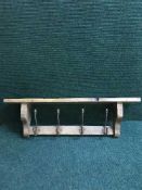A reclaimed pine four-hook coat rack