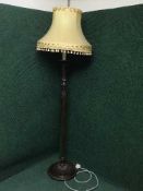 A carved mahogany standard lamp