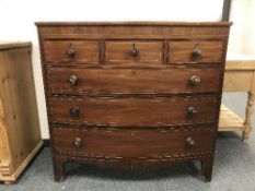 An early 19th century inlaid mahogany bow-fronted six drawer chest