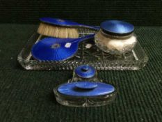 A five piece silver and enamelled dressing table set together with a silver and enamel lidded jar