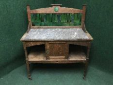 An Edwardian oak marble topped wash stand