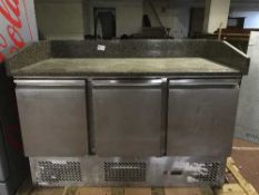 A stainless steel marble top triple door refrigerated counted