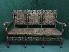 An early 20th century carved oak settle