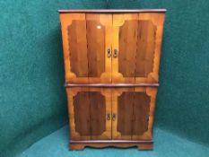 An inlaid yew wood TV cabinet