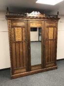 An Aesthetic period inlaid mahogany triple mirror door wardrobe,