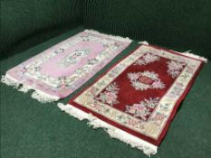 A pink fringed embossed Chinese rug and one other