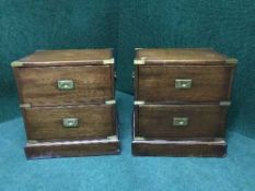 A pair of brass bound two drawer chests