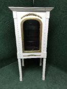 A white and gilt four sided display cabinet