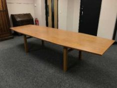 A very large teak coffin shaped dining table,