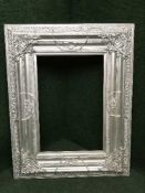 A large ornate silvered frame