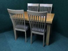 A stained kitchen table and four beech chairs