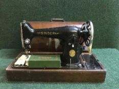 A mahogany cased Singer sewing machine and a pine stool