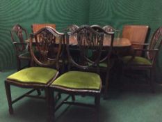 A Regency style twin pedestal table and eight shield back dining chairs