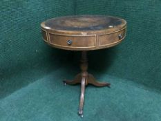 A leather topped drum table on three way pedestal