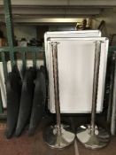 Three metal security bollard and three display boards with stands