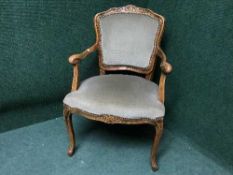 A mahogany armchair in green fabric