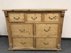 An antique style seven drawer pine chest