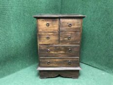 A contemporary hardwood eight drawer chest