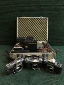 An aluminium camera case with cameras - Minolta XD7, Zenit E,