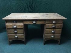 An early 20th century oak twin pedestal desk