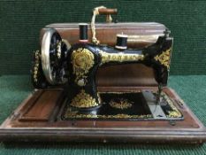 A Jones hand sewing machine and a case of 45's