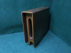 A narrow teak drop leaf table