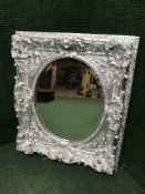 An ornate silvered framed mirror