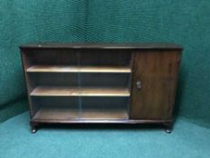 A walnut sliding door bookcase