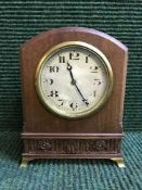An inlaid mahogany arched topped mantel clock