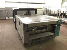 A commercial Cuppone stainless steel pizza oven on two tier table