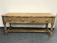 An antique style pine two drawer table,